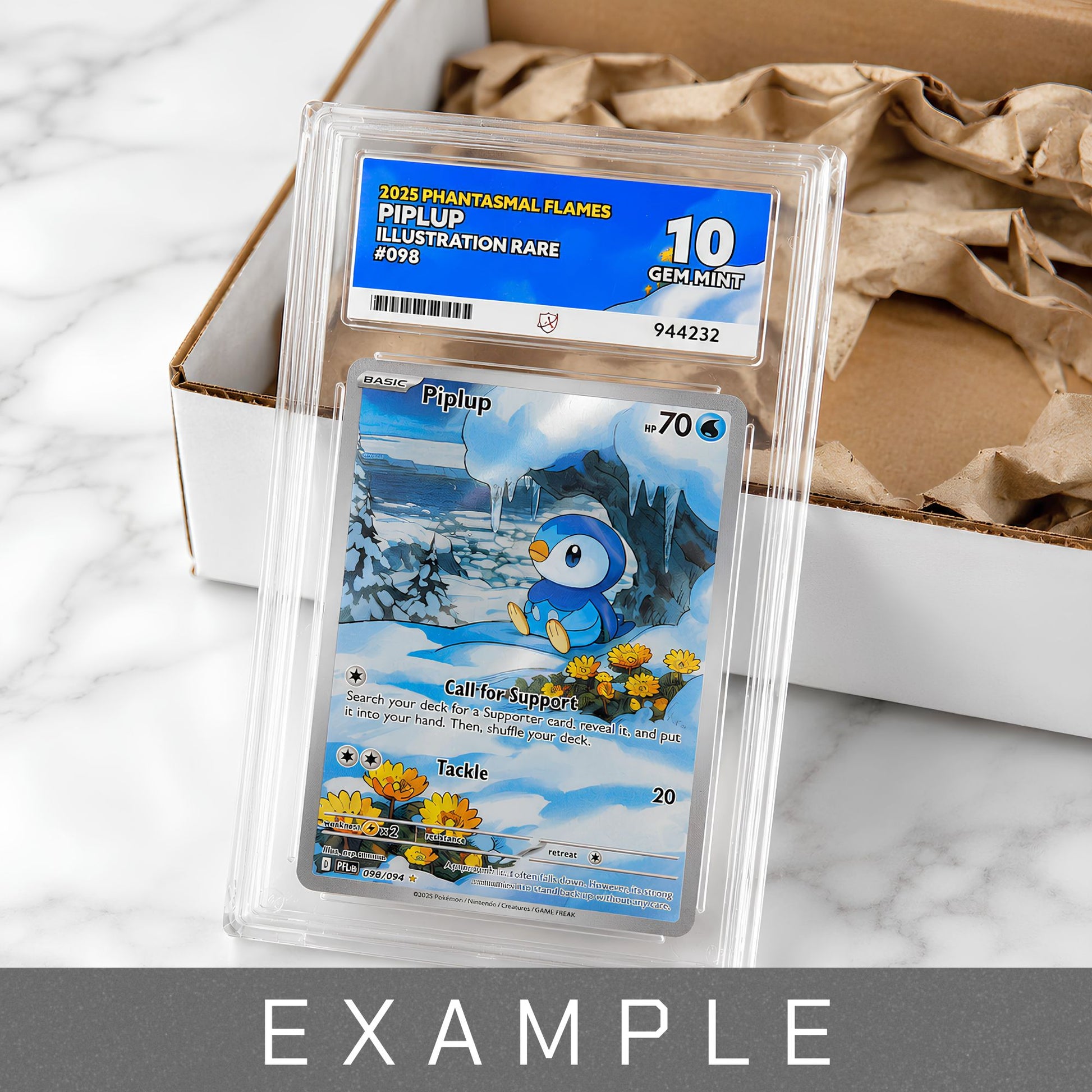 A graded Piplup Gem Mint 10 trading card in a clear plastic holder with a blue and white Gem Mint 10 label, placed on top of a cardboard box with brown packing paper. The card artwork shows a blue bird character in a snowy landscape.